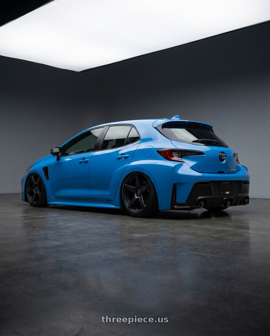 2024 Toyota GR Corolla with Forgestar CF5 5x114.3 18x10 +42 Satin Black wheels rear three quarter view slight stretch tires