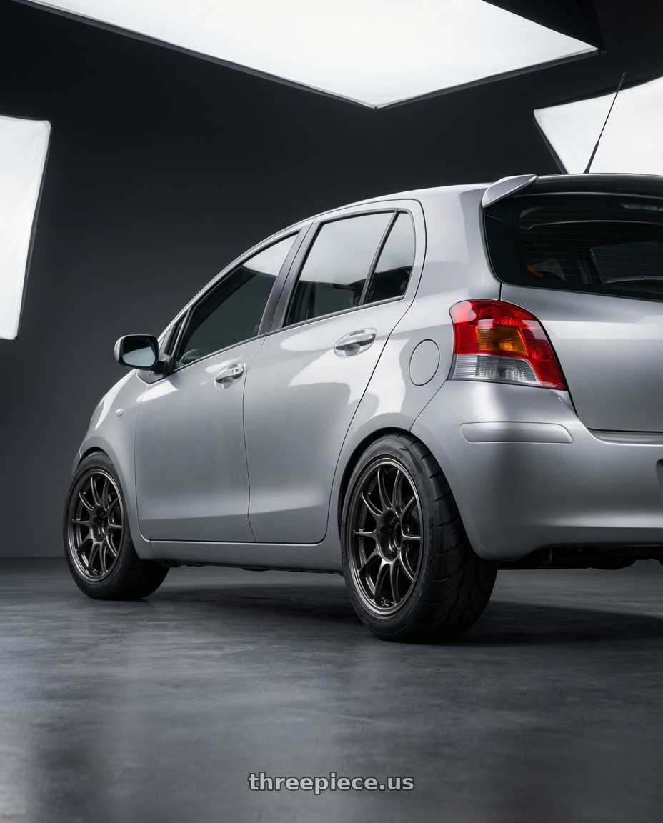 2009 toyota yaris with WedsSport TC105X 4x100 15x7.0+35 EJ Titan wheels rear three quarter view meaty tires