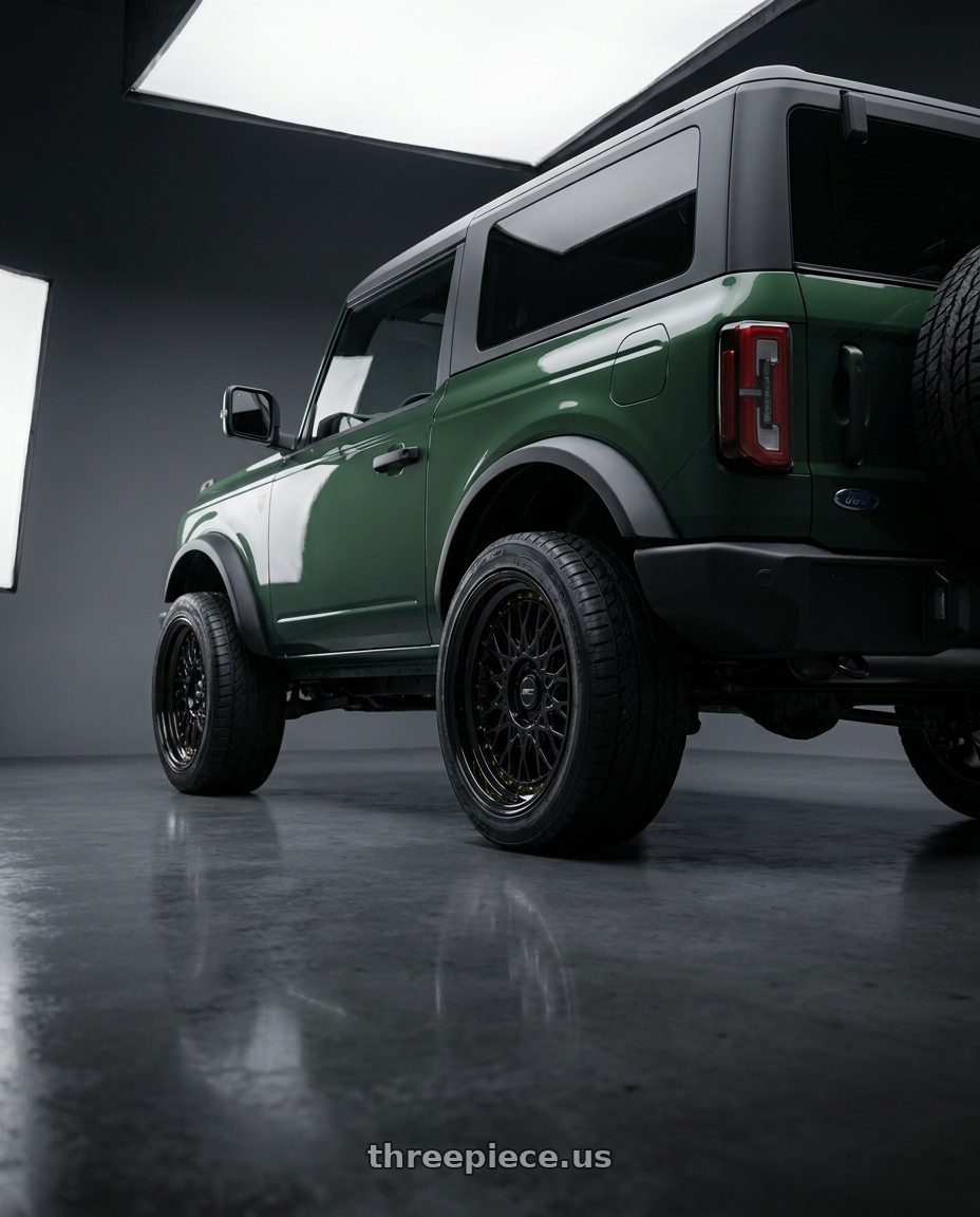 2025 Ford Bronco Wildtrak 2 with ARC AR1 5x120 17x8.5  +35 All Black Gold Rivet wheels rear three quarter view extreme stretch tires