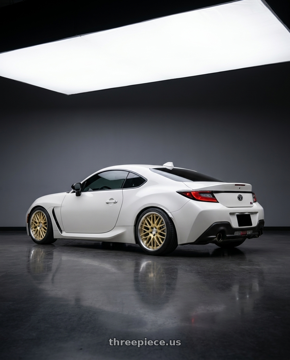 2026 Toyota gr86 with Work Lanvec Lm1 5x100 18x8.5+38 A Disk Light Metallic Gold wheels rear three quarter view square tires