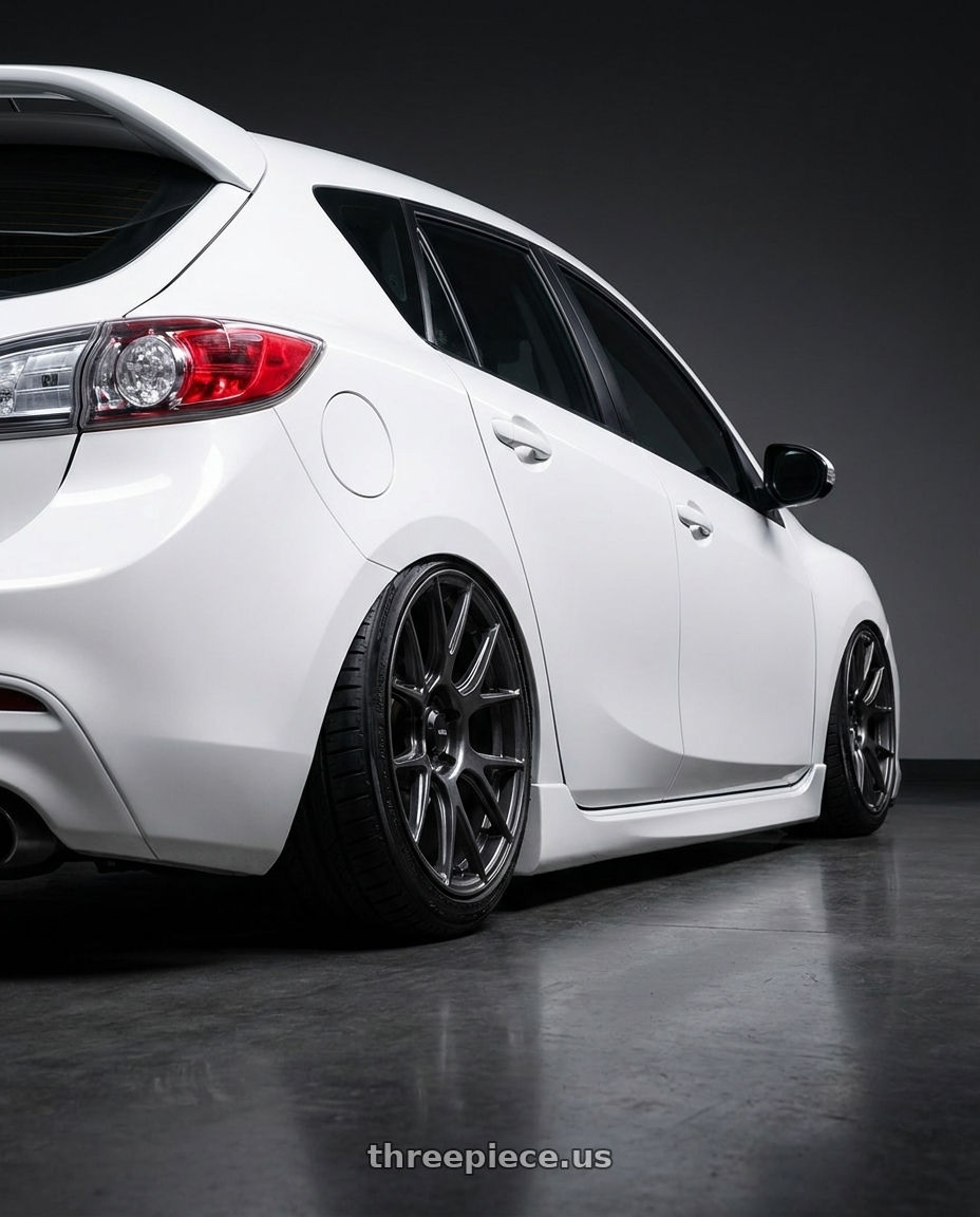 2012 Mazda Mazdaspeed3 with Konig Ampliform 5x114.3 18x9.5+35 Dark Metallic Graphite wheels rear three quarter view slight stretch tires