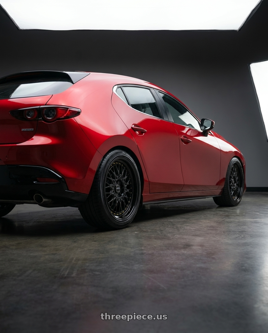 2024 Mazda 3 with ARC AR1 5x108 18x8.5  +35 All Black Gold Rivet wheels rear three quarter view slight stretch tires