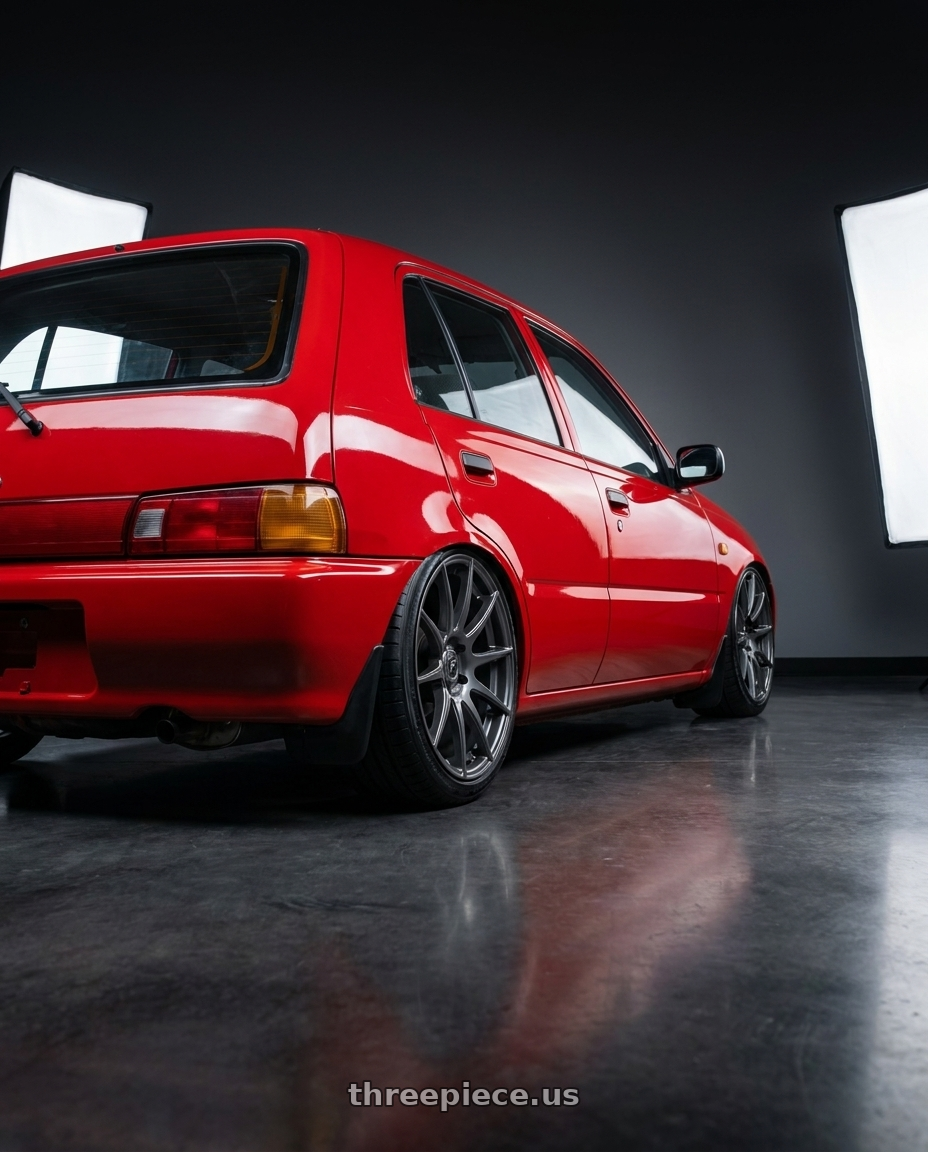 1994 Daihatsu charade with Forgestar CF10 5x114.3 19x9 +35 Gloss Anthracite wheels rear three quarter view slight stretch tires