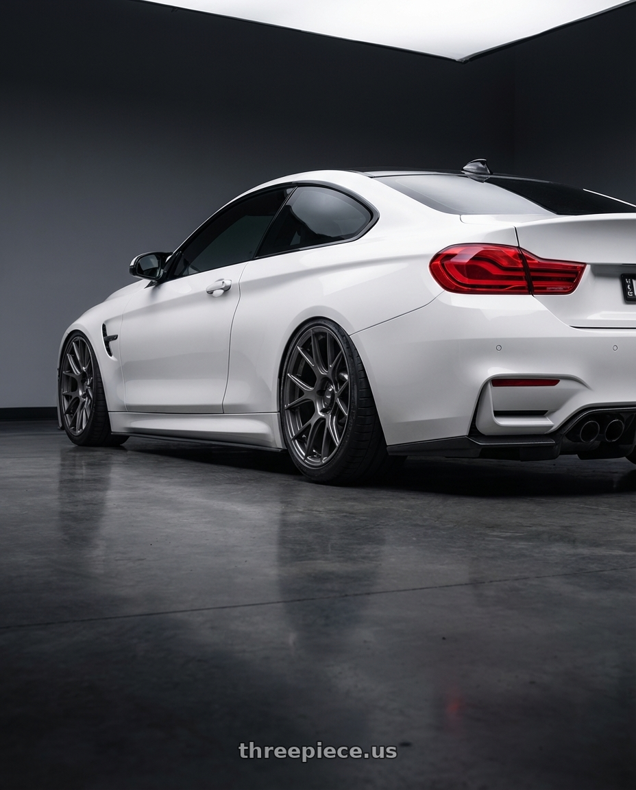 2018 BMW M4 F82 with Konig Ampliform 5x120 19x10+28 Dark Metallic Graphite wheels rear three quarter view slight stretch tires