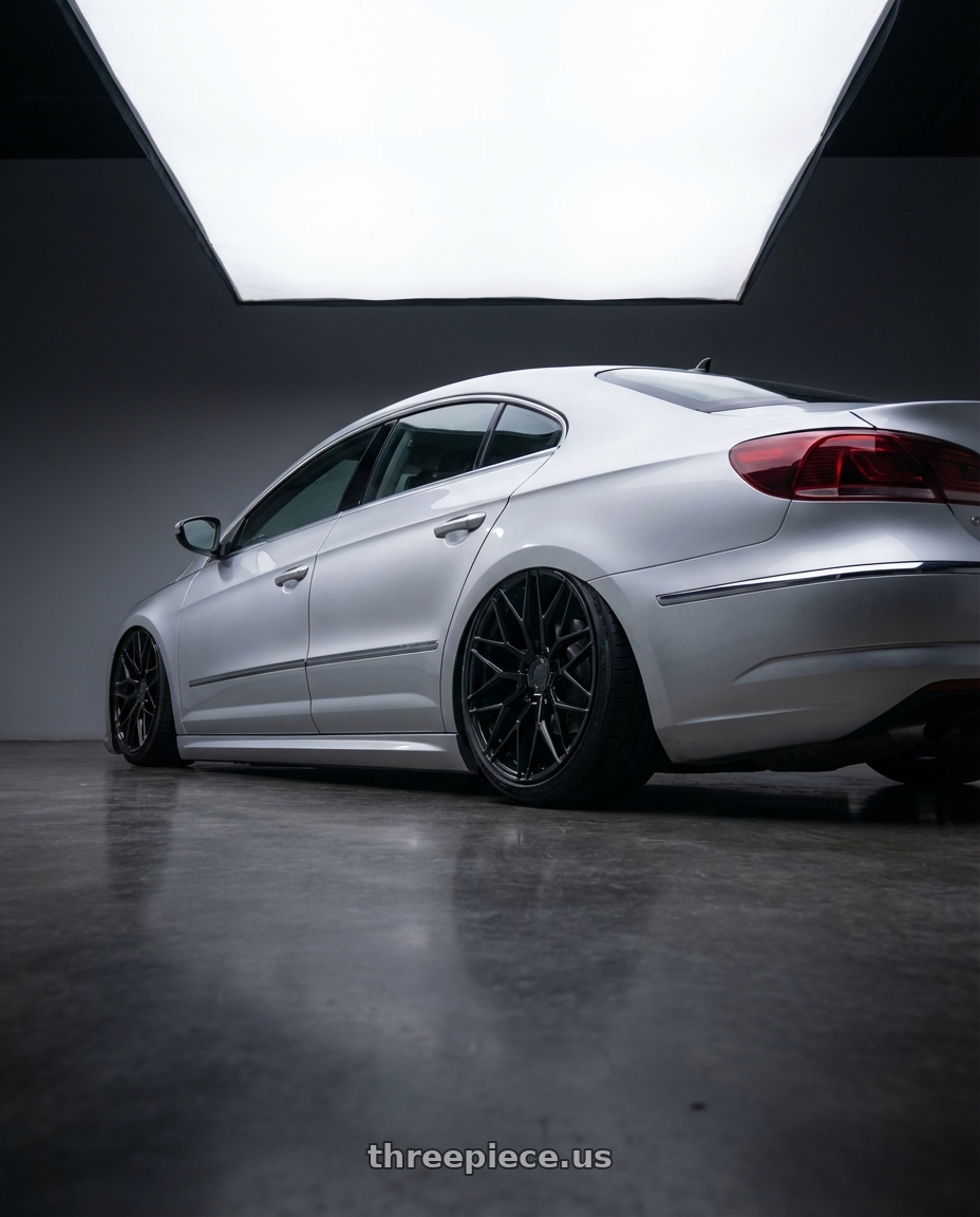 2015 Volkswagen CC with Avant Garde Wheels M520R 5X112 19x8.5 +35 Gloss Black wheels rear three quarter view slight stretch tires