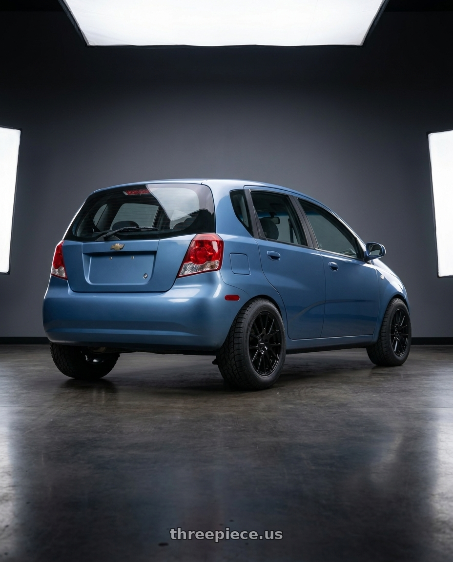 2005 Chevy Aveo with Vision Street-Designs 18 Hellion 4x100 14x5.5+38 Gloss Black wheels rear three quarter view meaty tires