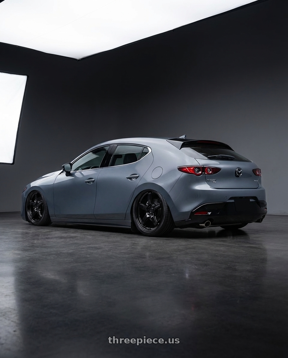 2023 Mazda Mazda3 Turbo with Gram Lights 57CR 5x114.3 18x8.5+37 Glossy Black wheels rear three quarter view slight stretch tires