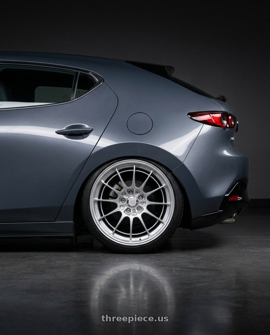 2026 Mazda 3 with Enkei NT03+M 5x114.3 18x8.5+38 Silver wheels rear three quarter view square tires