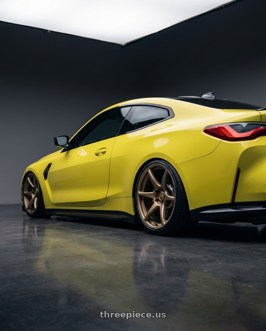 2024 BMW M4 G82 with Kansei K11B Tandem 5X112 19x9.5 22 Bronze wheels rear three quarter view slight stretch tires