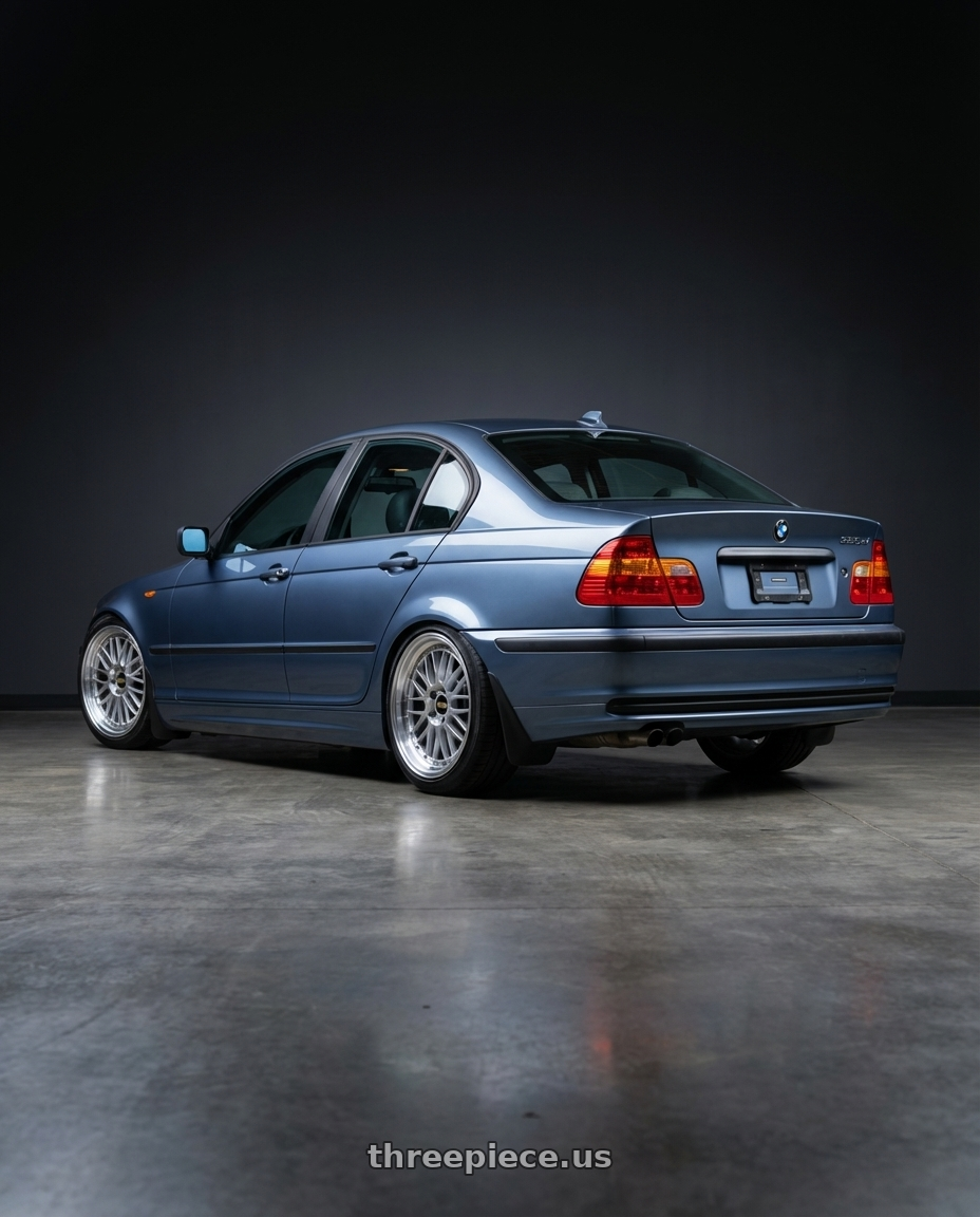 2003 BMW 325xi sedan blue with BBS LM 5x120 17x8.0+40 Diamond Silver wheels rear three quarter view square tires