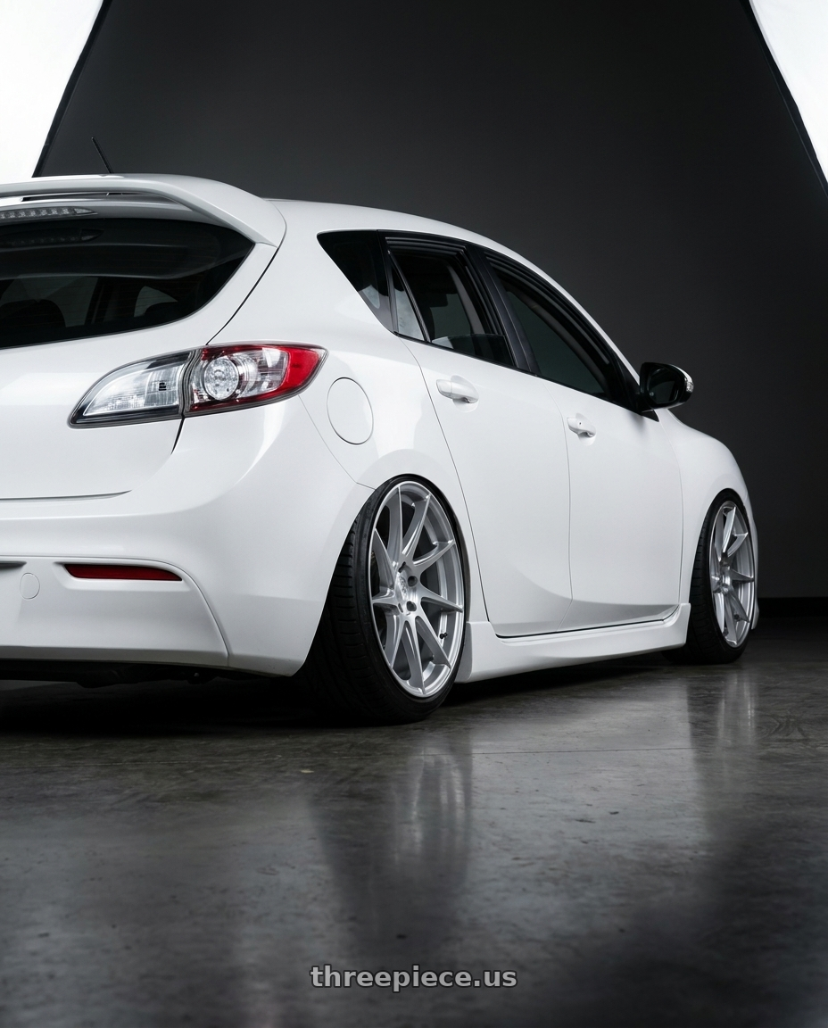 2012 Mazda Mazdaspeed3 with Aodhan AH09 5x114.3 18x8.5 +35 Gloss Silver Machined Face wheels rear three quarter view slight stretch tires
