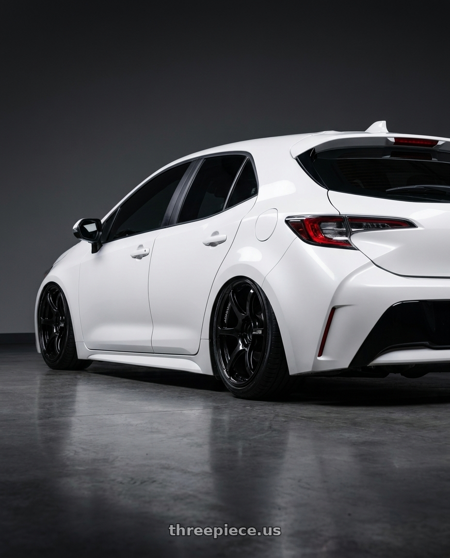 2023 Toyota Corolla Hatchback with Advan RGIII 5x114.3 18x10.5+25 Gloss Black wheels rear three quarter view slight stretch tires