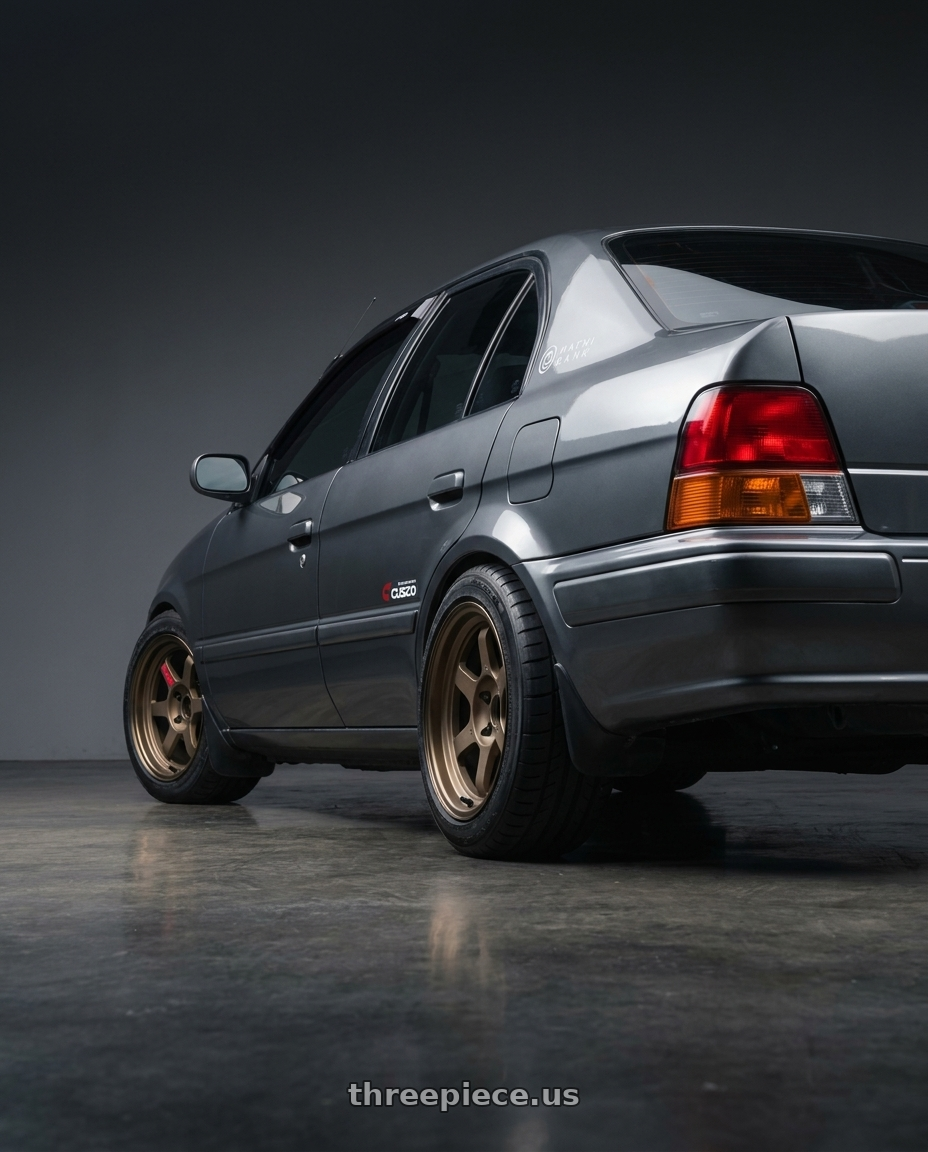 1996 Toyota Tercel EL51 with Volk Racing TE37V 4x100 15x8.0+25 wheels rear three quarter view square tires