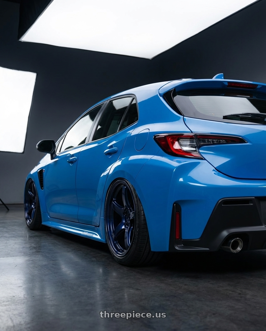2024 Toyota GR Corolla with Gram Lights 57CR 5x114.3 18x9.5+12 Eternal Blue Pearl wheels rear three quarter view slight stretch tires