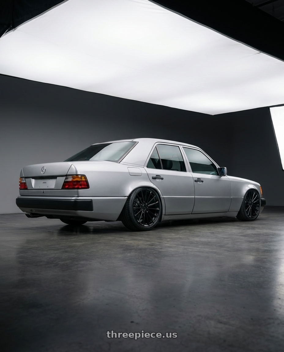 1995 Mercedes w124 with OHM PROTON 5X105 17X6.5 +45 GLOSS BLACK wheels rear three quarter view slight stretch tires