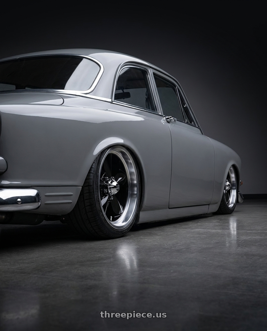 1962 Volvo 122 with US Mag 1PC U107 STANDARD 5X114.3 17X7 +1 GLOSS BLACK wheels rear three quarter view square tires