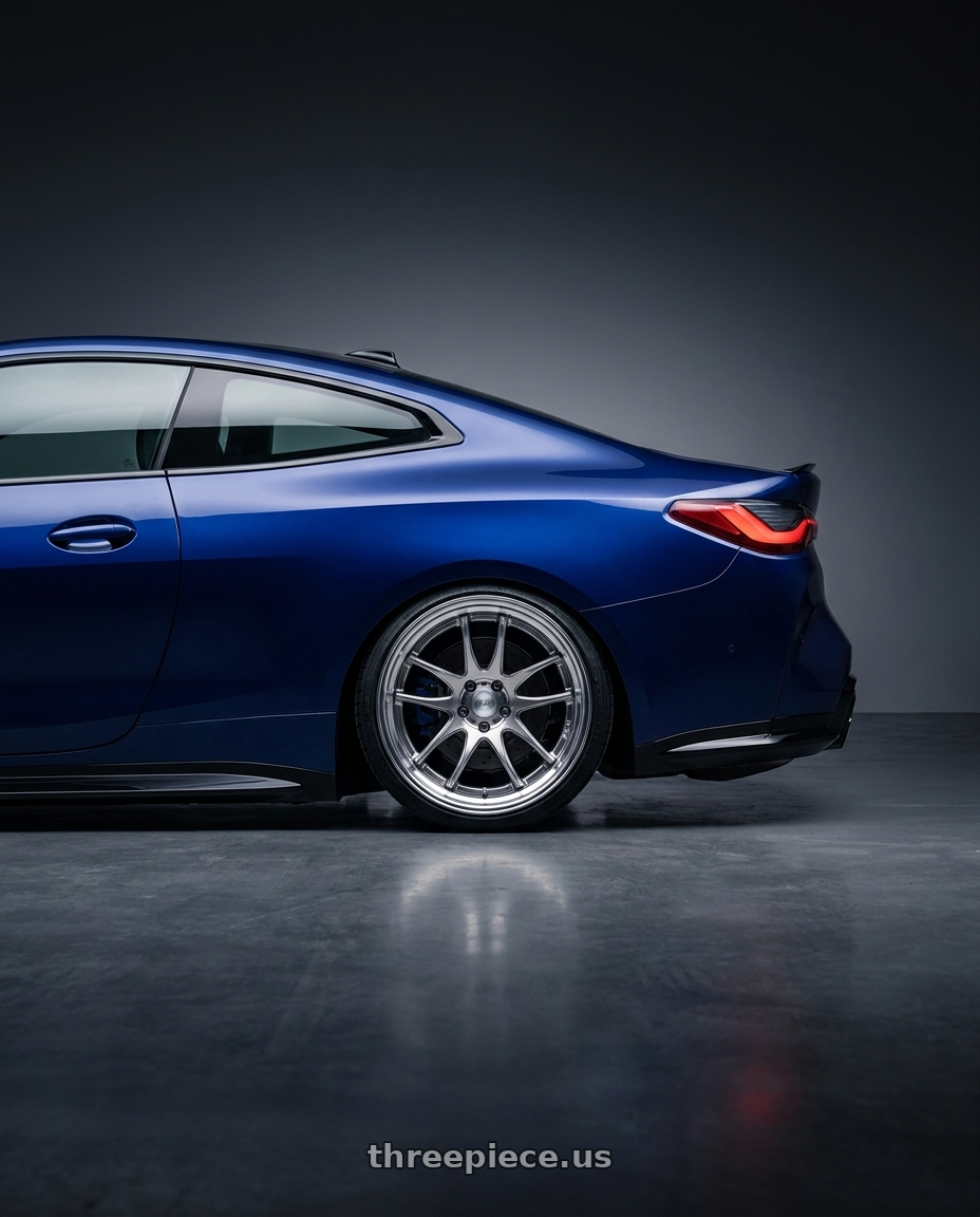 2025 bmw m4cx tanzanite blue with Work Cr 2P 5x112 20x10.0 +18 GT Silver wheels rear three quarter view square tires