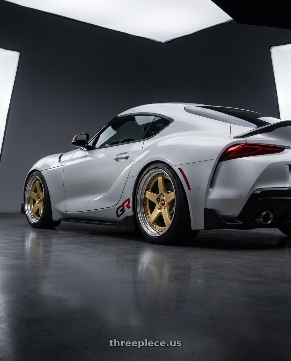 2026 toyota GR supra final with Work Zistance W5s 5x112 19x10+38 s disk Gold wheels rear three quarter view square tires