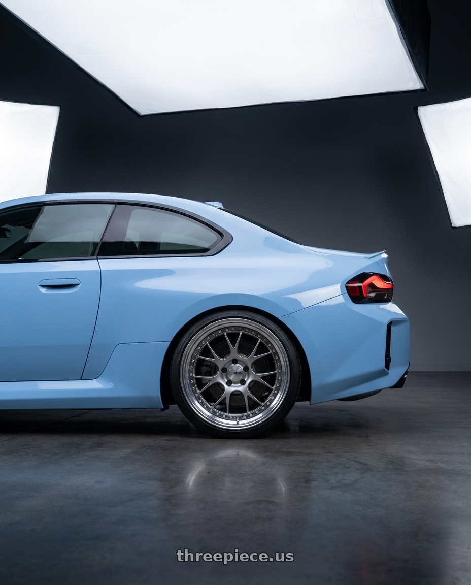 2026 bmw m2 with SSR Professor MS3 5x112 20x11+24 SL Disk Titan Silver wheels rear three quarter view square tires