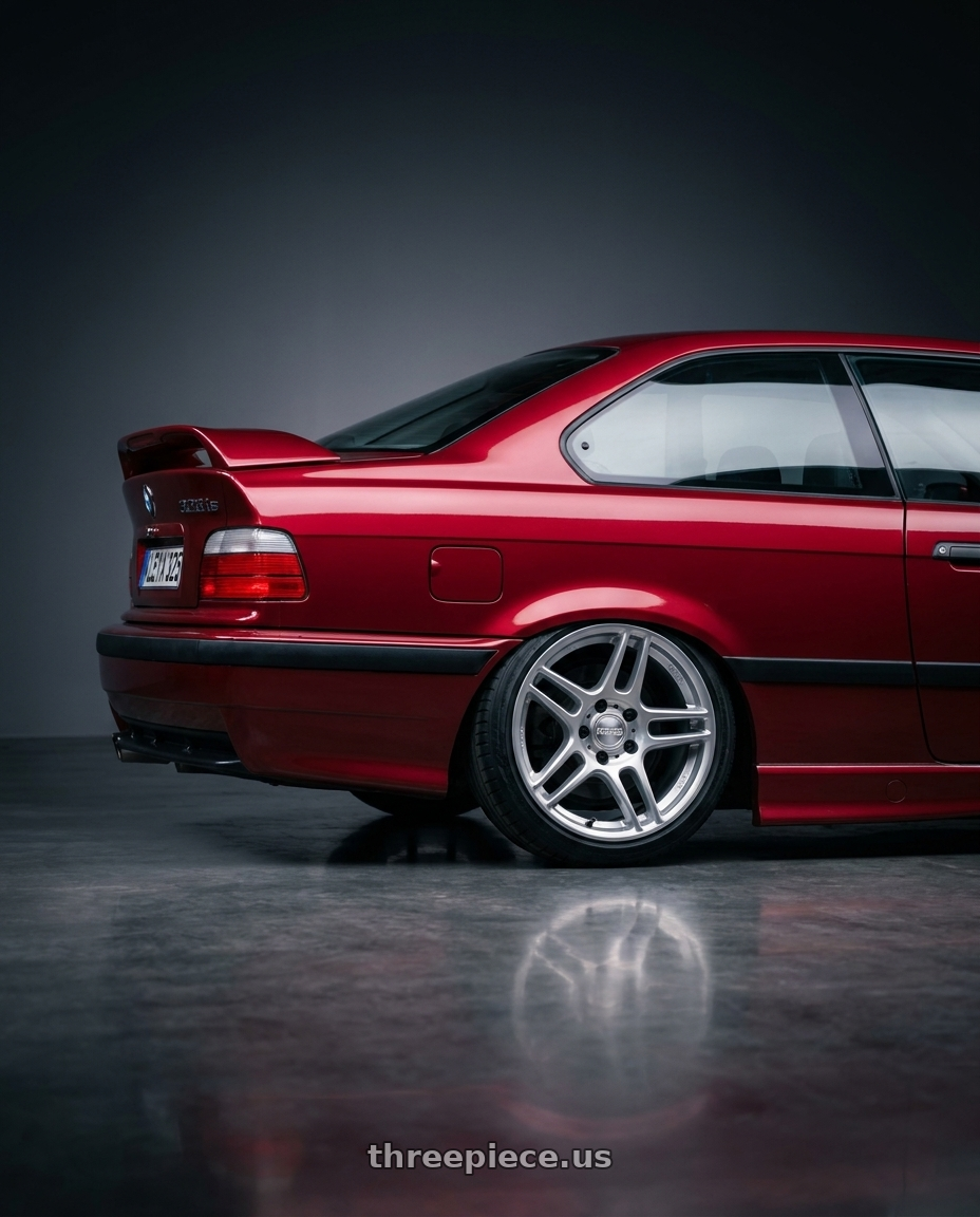 1996 BMW E36 328is with Kansei K11S Tandem 5X100 17x9 35 Hyper Silver wheels rear three quarter view slight stretch tires