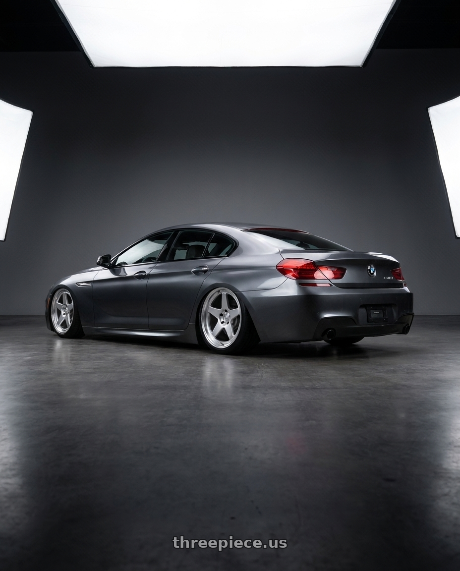 2015 BMW 640i Gran Coupe with Kansei K12H KNP 5X120 17x9 35 Hyper Silver wheels rear three quarter view slight stretch tires