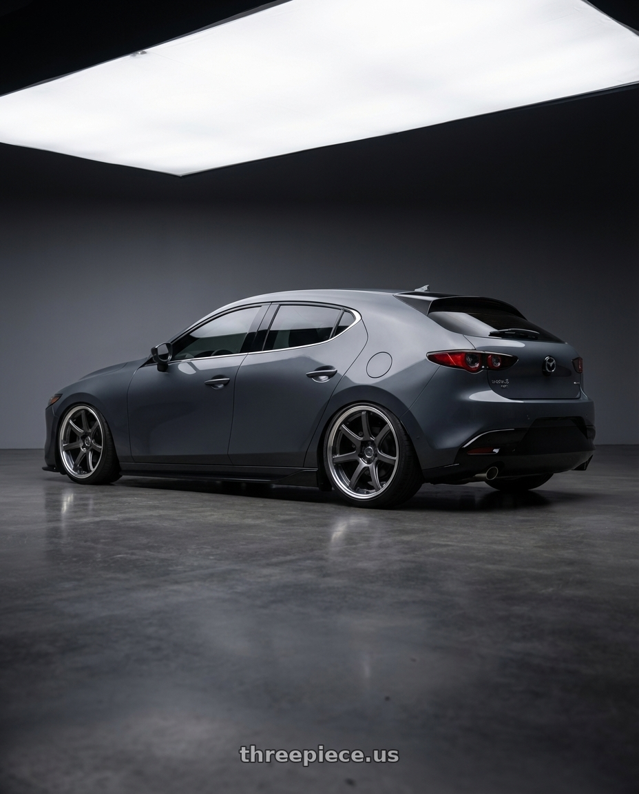 2025 mazda 3 hatchback turbo premium plus, dark grey, black wheels with Work Emotion T7R 2P wheels rear three quarter view square tires