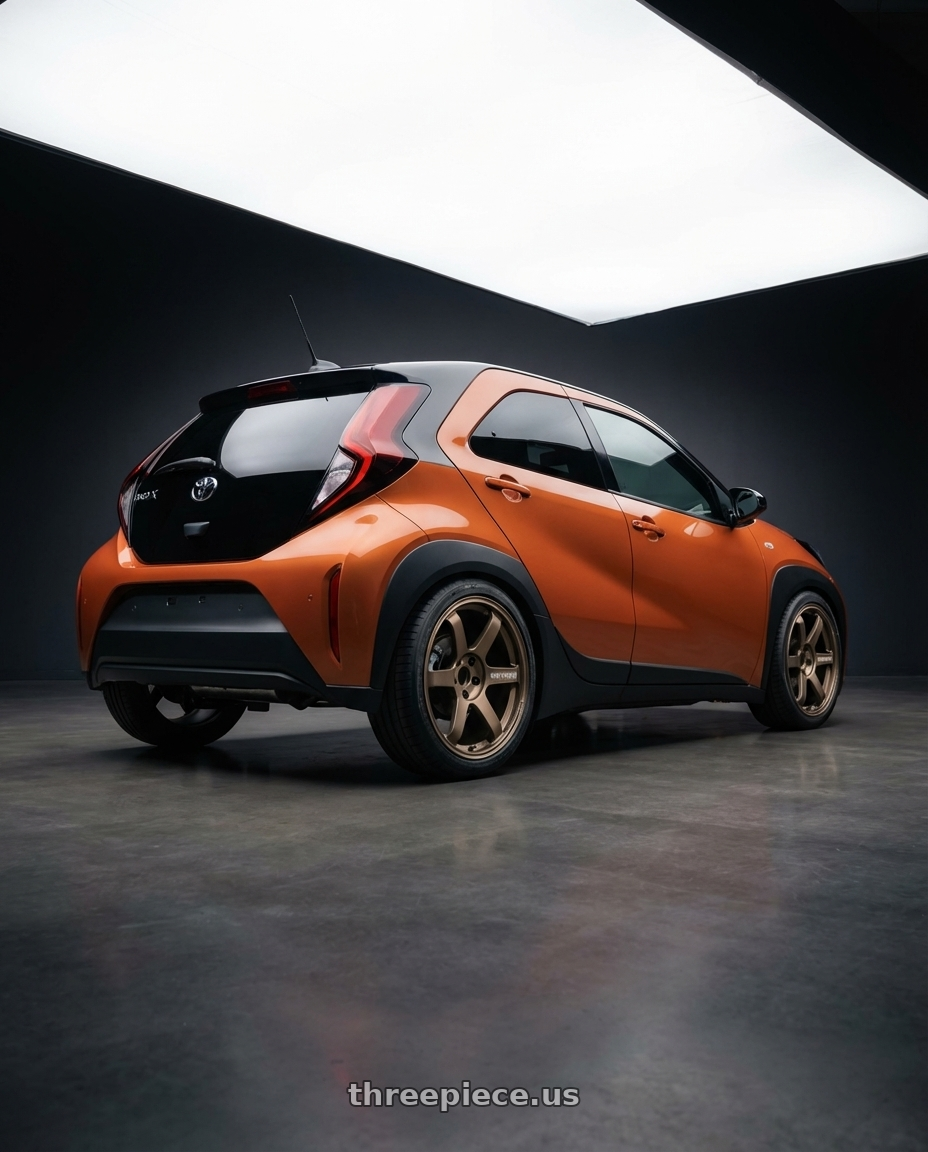 2026 Toyota Aygo X Hybrid with Volk Racing TE37 SAGA 5x110 17x8 +26 BRONZE wheels rear three quarter view square tires