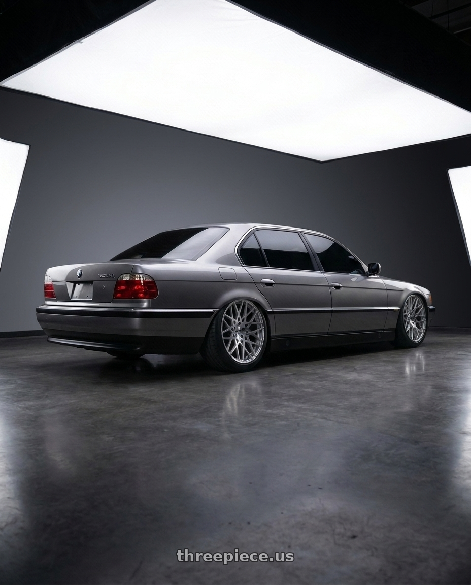 1997 BMW 740il with TSW VALE 5X120 18X9.5 +20 SILVER W/ MIRROR CUT FACE wheels rear three quarter view extreme stretch tires