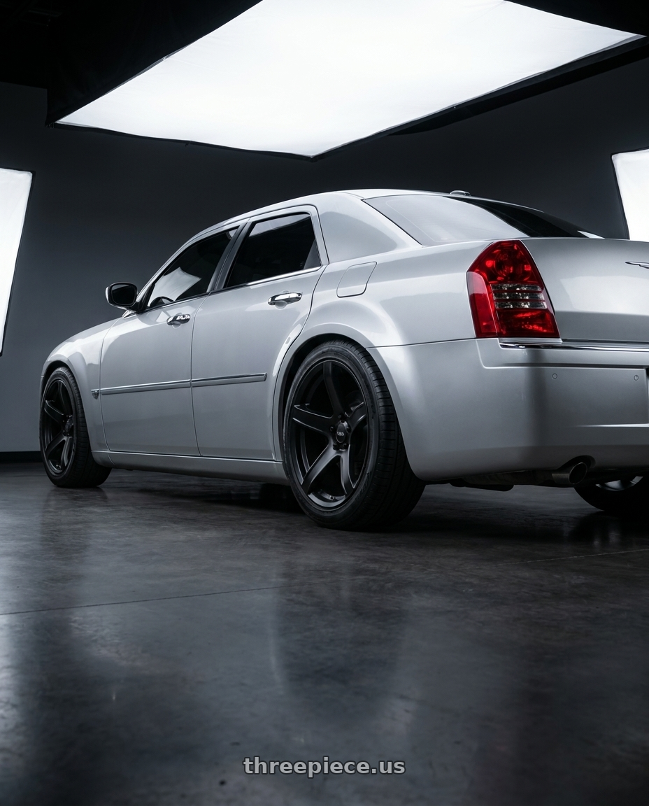 2005 Chrysler 300c with Voxx Replica Hellcat 2 5x115 20x9.5+18 Matte Black wheels rear three quarter view square tires