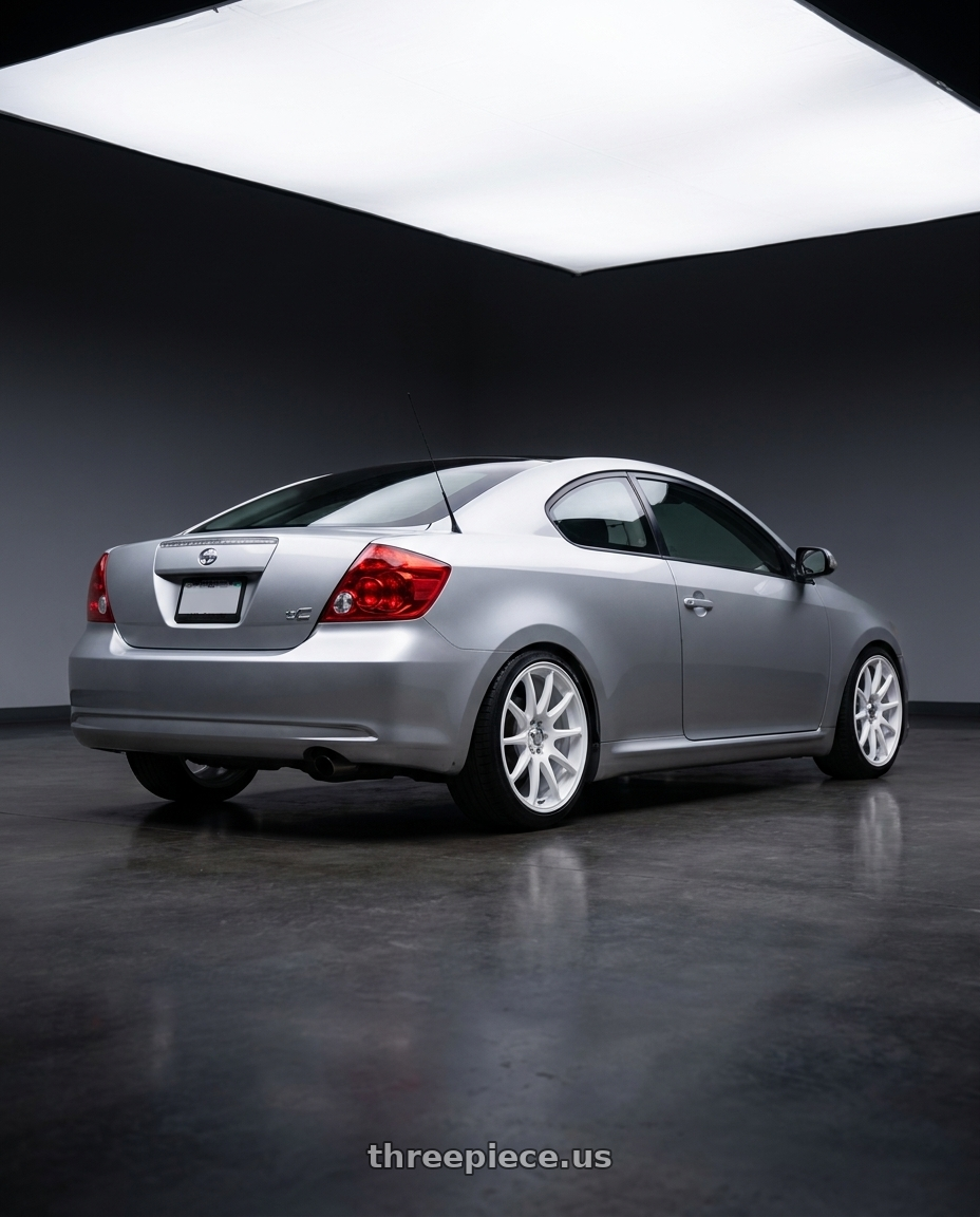 2007 scion tC silver with RTX Stag 5x100 17x8 +35 Satin White wheels rear three quarter view square tires