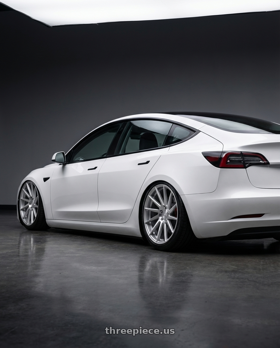 2023 Tesla Model 3 with Niche 1PC M112 SURGE 5X114.3 19X8.5 +35 GLOSS SILVER MACHINED wheels rear three quarter view slight stretch tires