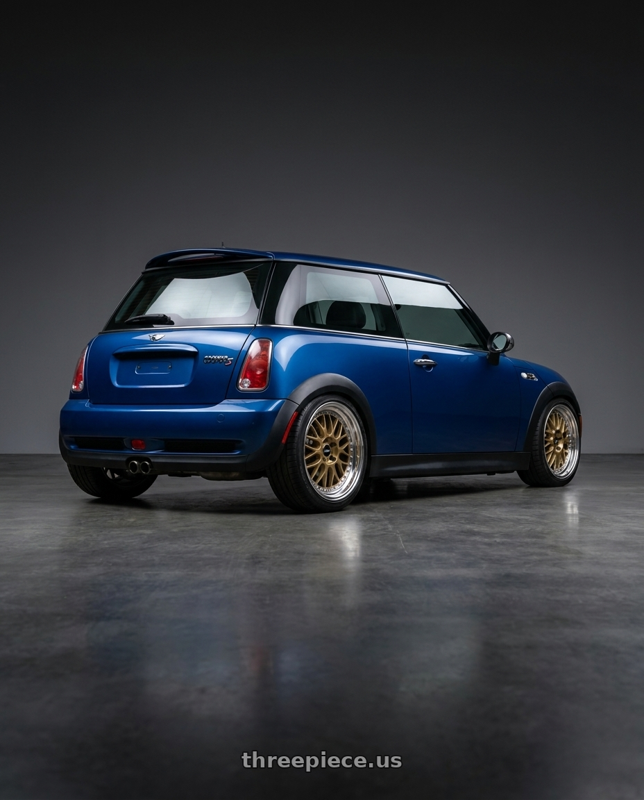 2006 mini cooper s  with Work Meister M1 3p 4x100 16x7+43 O Disk Titanium Gold wheels rear three quarter view square tires