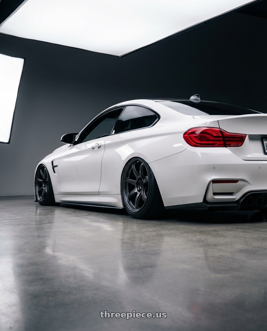 2018 BMW M4 F82 with Gram Lights 57Transcend 5x120 19x10.5+35 Face 2 Super Dark Gunmetal wheels rear three quarter view slight stretch tires