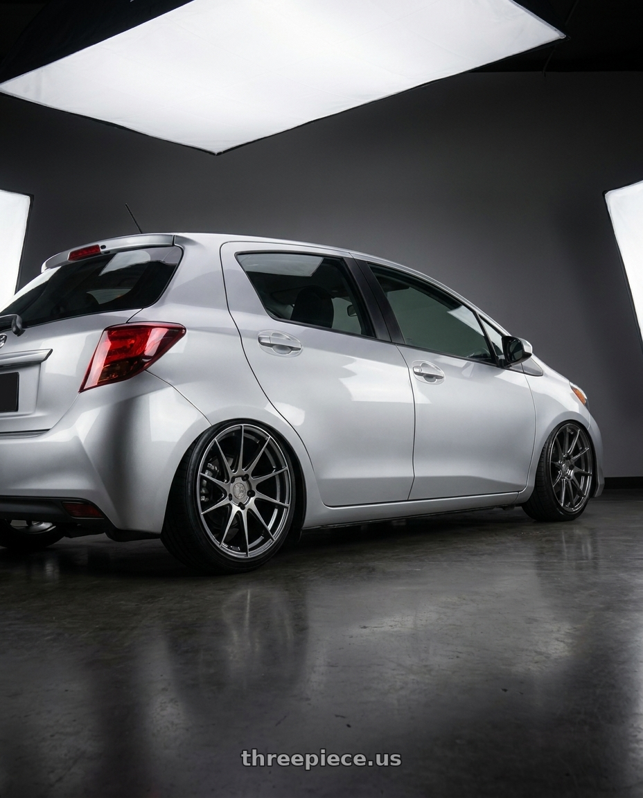 2015 Toyota yaris with Aodhan AH09 5x112 18x9.5 +35 Hyper Black wheels rear three quarter view slight stretch tires