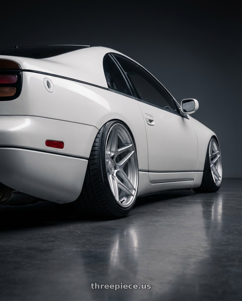 White 1990 Nissan 300zx with Kansei K15H Astro 5x114.3 18x9 22 Hyper Silver wheels rear three quarter view extreme stretch tires