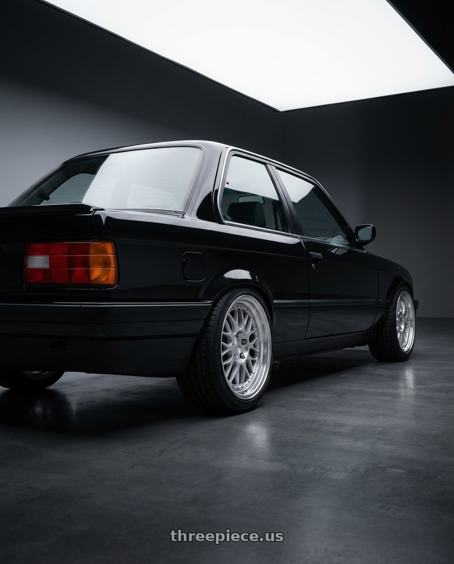 1991 bmw 325i coupe base, black with Work Seeker Fx 4x100 16x6.5+0 O Disk Matte Silver Polish wheels rear three quarter view square tires