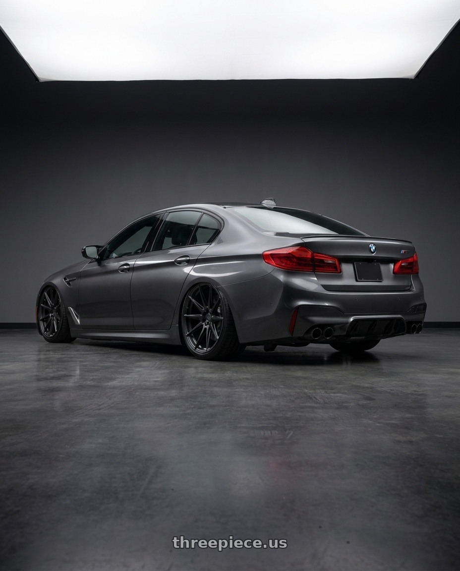 2020 BMW M5 with ADV.1 ADV5.0 5x112 20x11 +12 Satin Black wheels rear three quarter view slight stretch tires