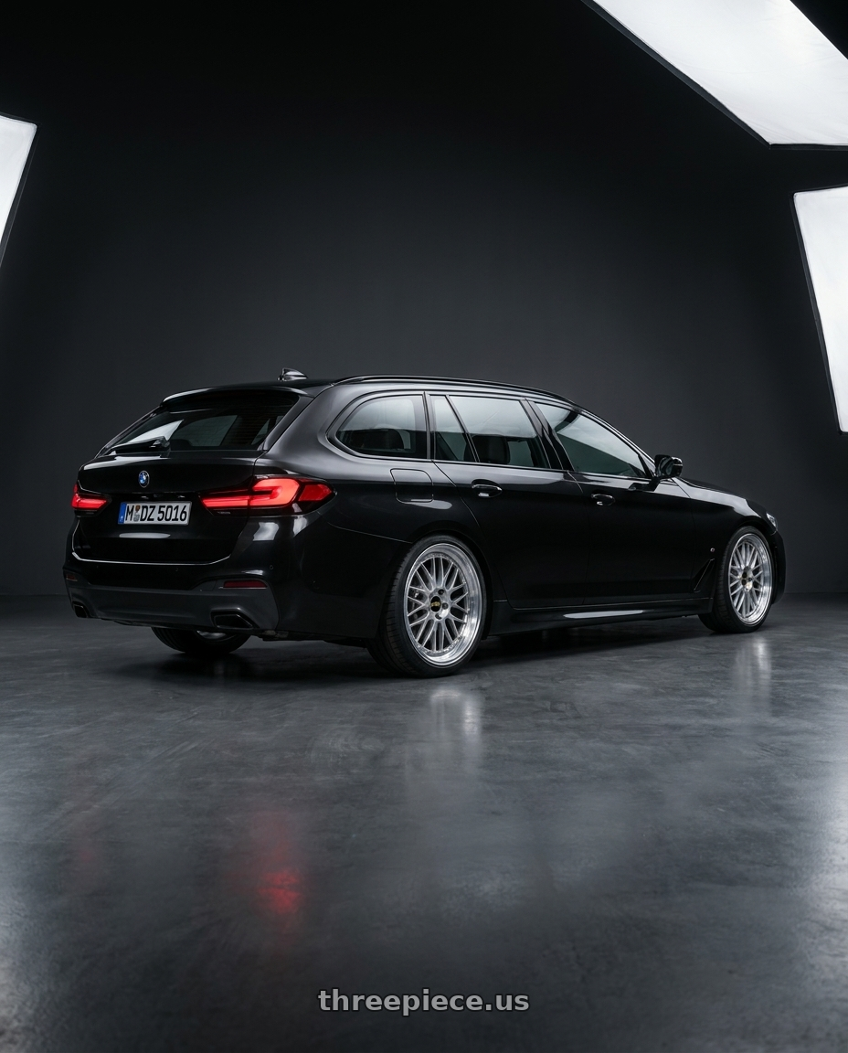 2026 BMW 520i touring M with BBS LM 5x120 21x9.0+32 Diamond Silver wheels rear three quarter view square tires