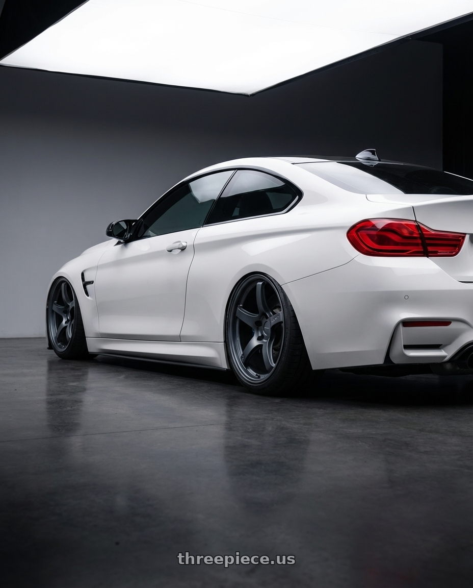 2018 BMW M4 F82 with Gram Lights 57CR 5x120 19x10.5+22 Gunblue II wheels rear three quarter view slight stretch tires