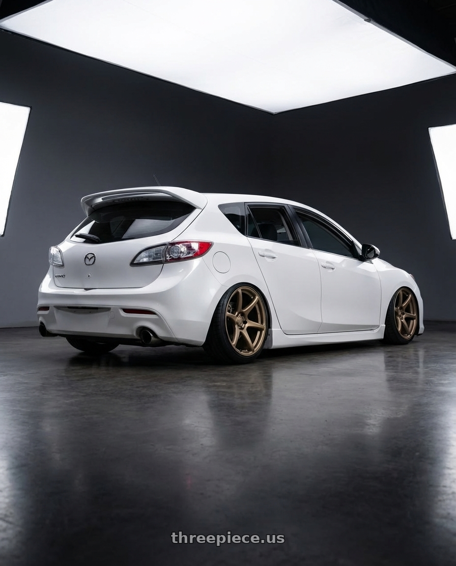 2012 Mazda Mazdaspeed3 with Kansei K11B Tandem 5x114.3 18x9.5 22 Bronze wheels rear three quarter view slight stretch tires