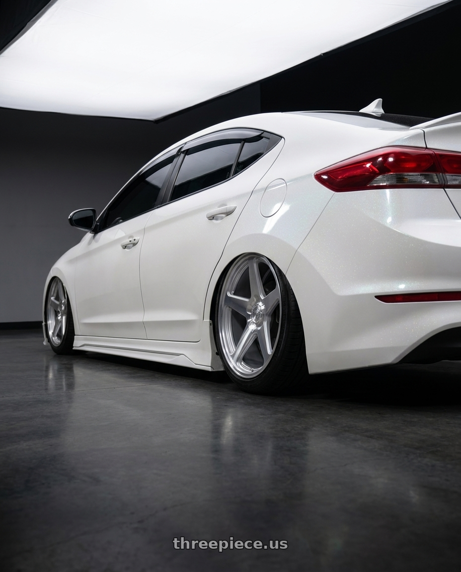 2018 Hyundai Elantra with DOLCE PERFORMANCE STELLA 5x120 18x8.5 +35 Gloss Silver wheels rear three quarter view slight stretch tires