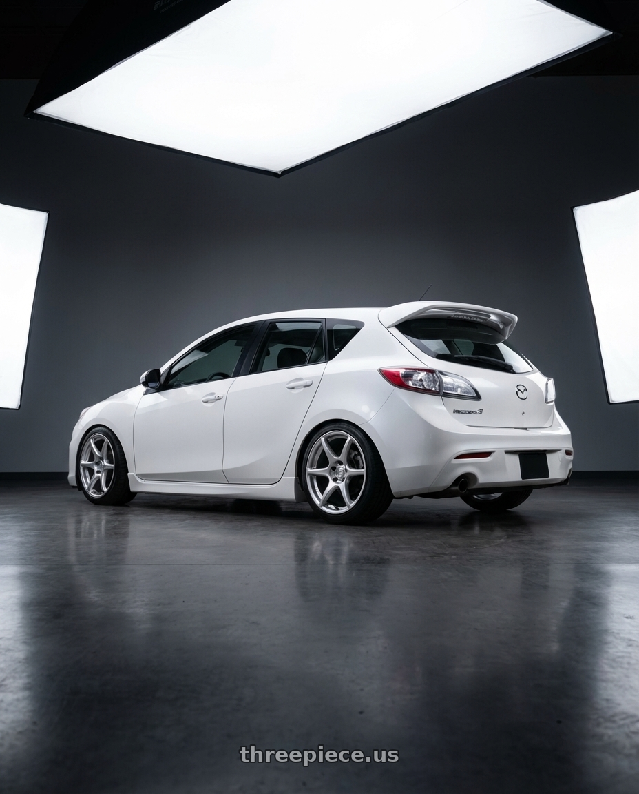 2012 Mazda Mazdaspeed3 with Kansei K11S Tandem 5x114.3 18x10.5 12 Hyper Silver wheels rear three quarter view square tires