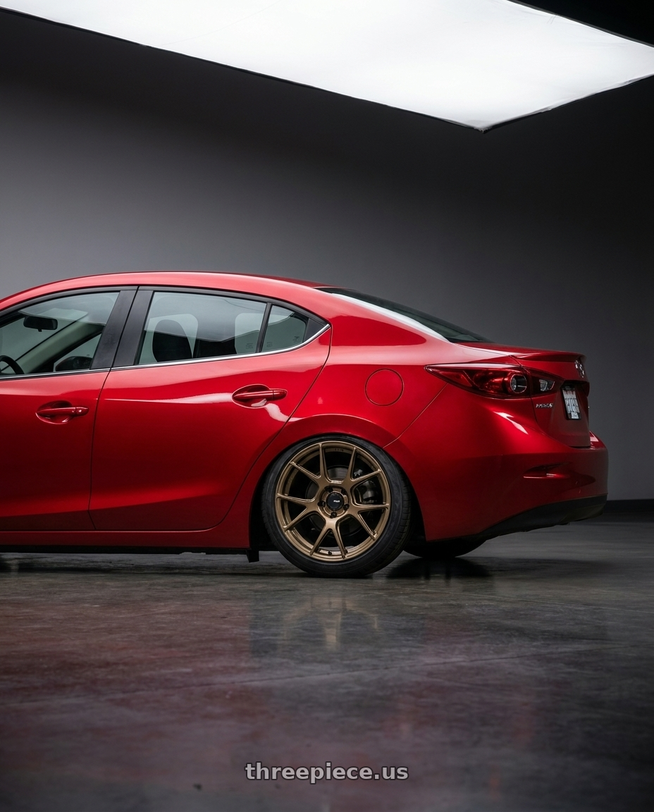 2016 Mazda 3 with Konig Ampliform 5x114.3 19x8.5+45 Gloss Bronze wheels rear three quarter view slight stretch tires