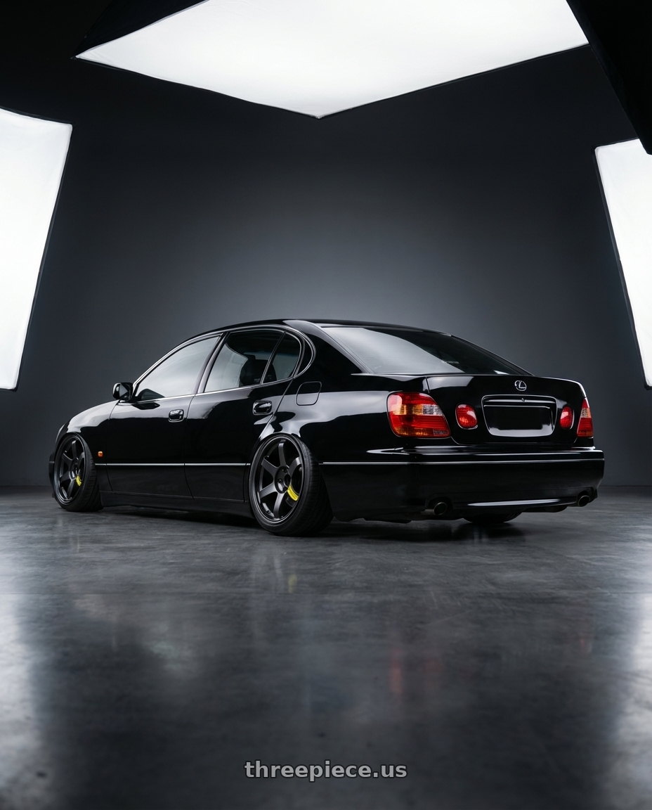 1999 lexus gs300 with Volk Racing TE37 Saga SL M-Spec 5x114.3 18x11.0+15 Pressed Black wheels rear three quarter view extreme stretch tires