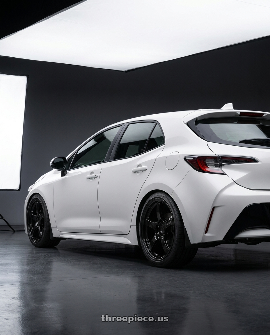 2023 Toyota Corolla Hatchback with Gram Lights 57CR 5x114.3 18x10.5+12 Glossy Black wheels rear three quarter view square tires