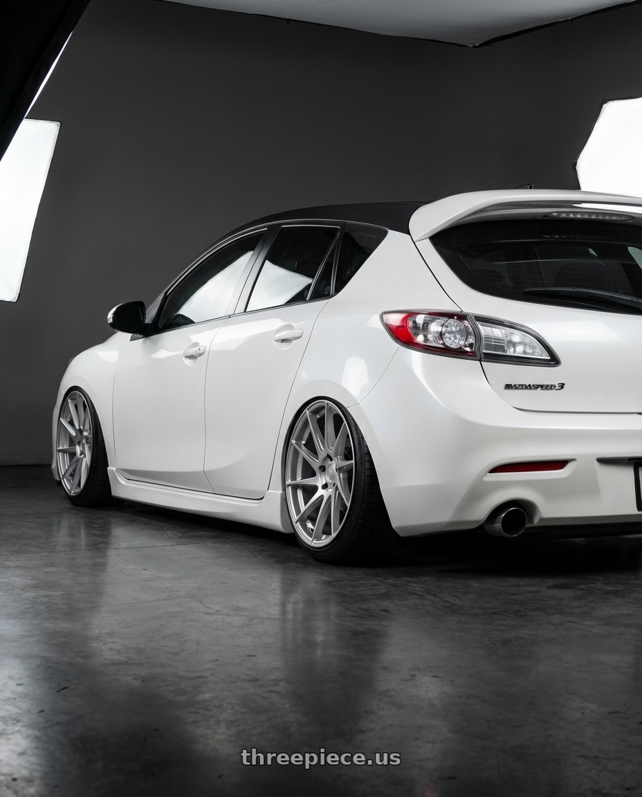 2012 Mazda Mazdaspeed3 with Aodhan AH09 5x114.3 18x8.5 +35 Gloss Silver Machined Face wheels rear three quarter view slight stretch tires