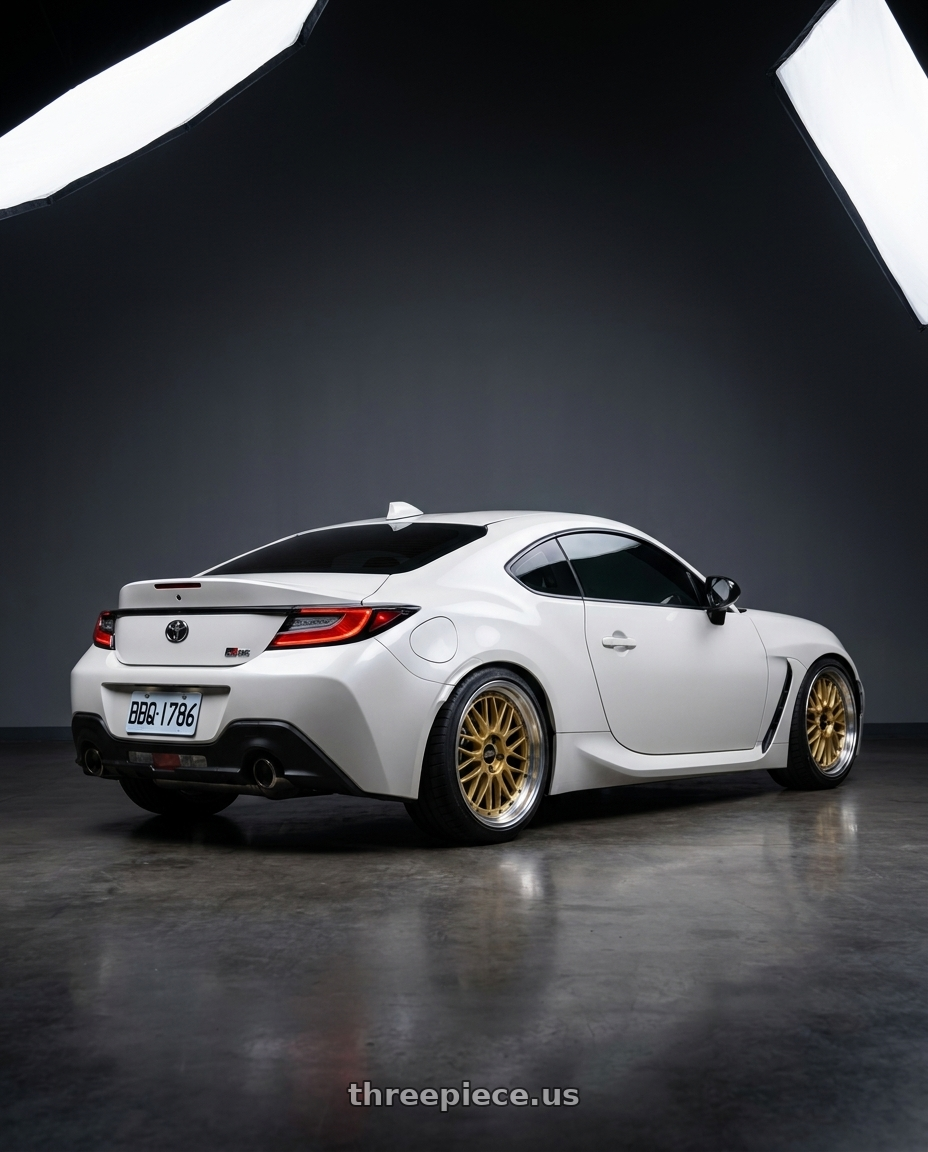 2023 Toyota GR86 with BBS LM 5x130 18x8.5+56 Gold wheels rear three quarter view square tires