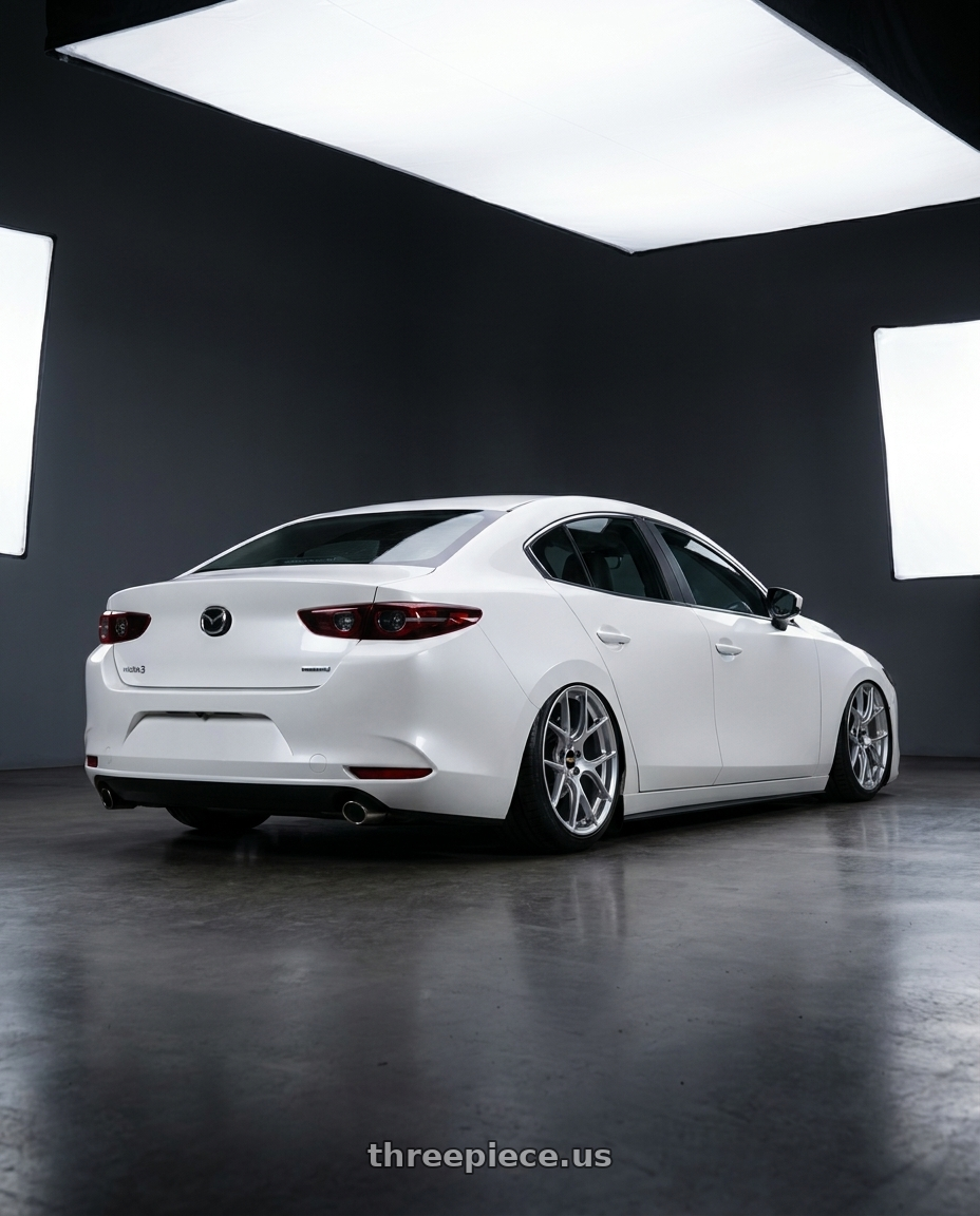 2022 Mazda3 white with BBS RE-V7 5x114.3 18x8.5 +42 Diamond Silver wheels rear three quarter view slight stretch tires