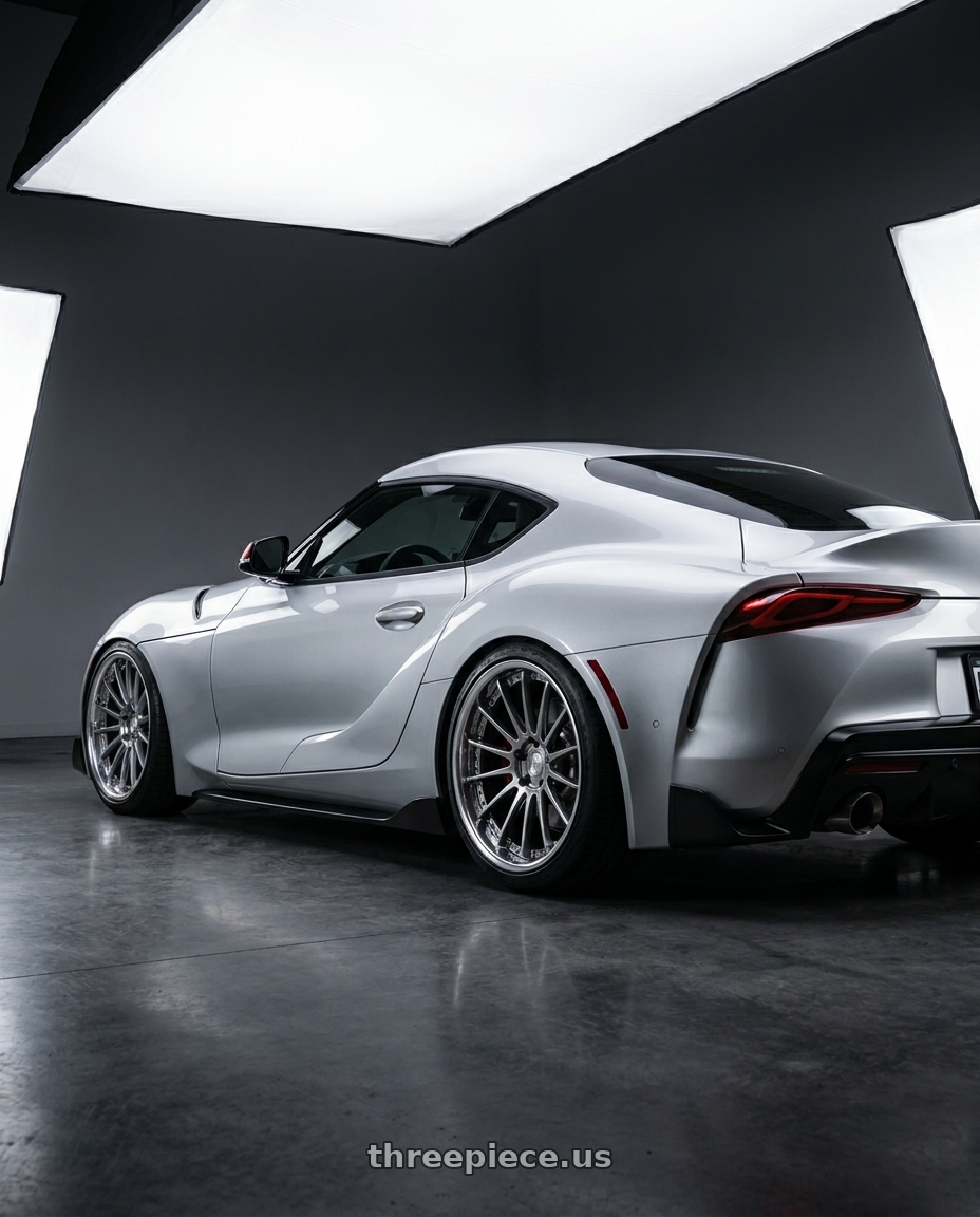 2020 gr supra premium with EXECUTOR CV04 5X112 20X10.5+38 NR Disk Titan Silver wheels rear three quarter view square tires