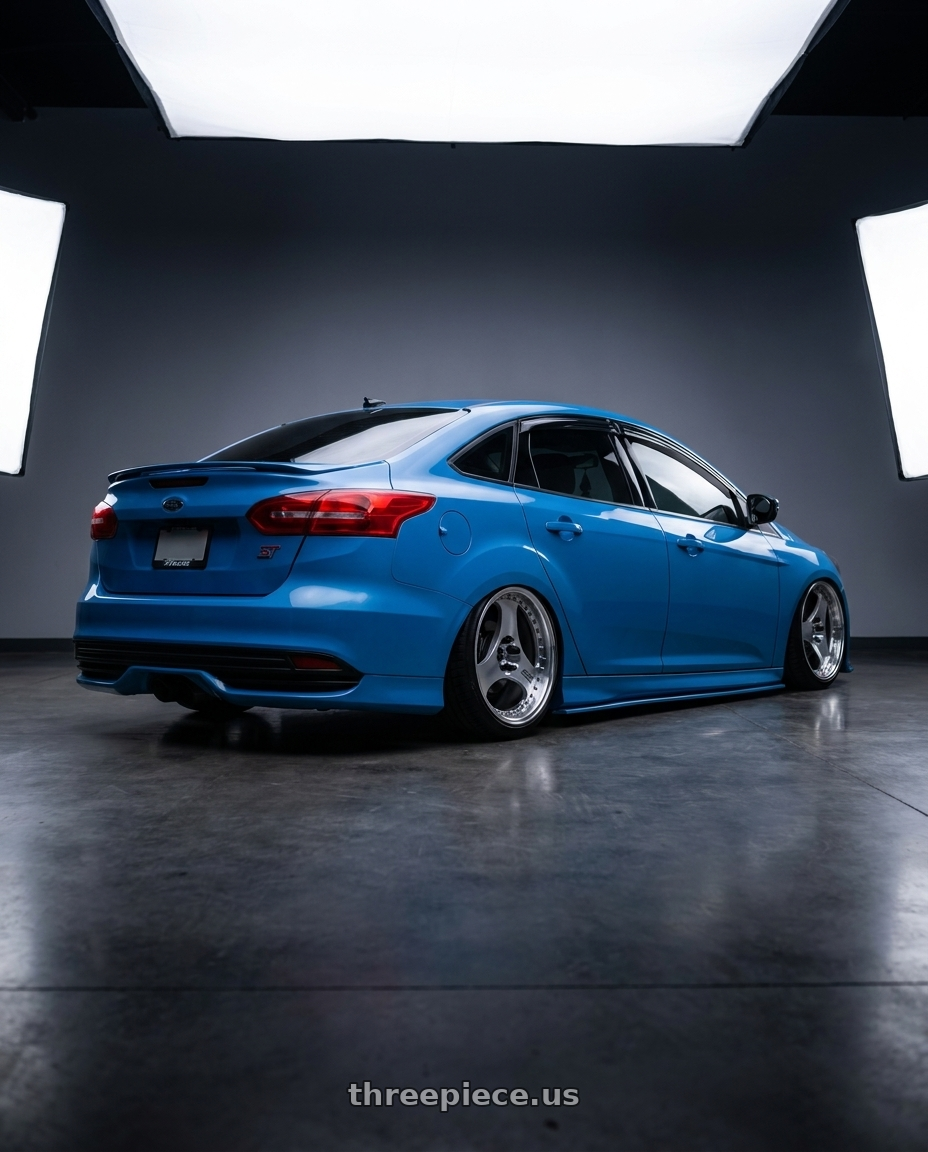 Blue 2016 ford focus sedan with st front end  with Advan Racing ONI2 PROGRESSIVE 5x114.3 20x9.5 +37 MACHINING & DIAMOND CUT wheels rear three quarter view slight stretch tires